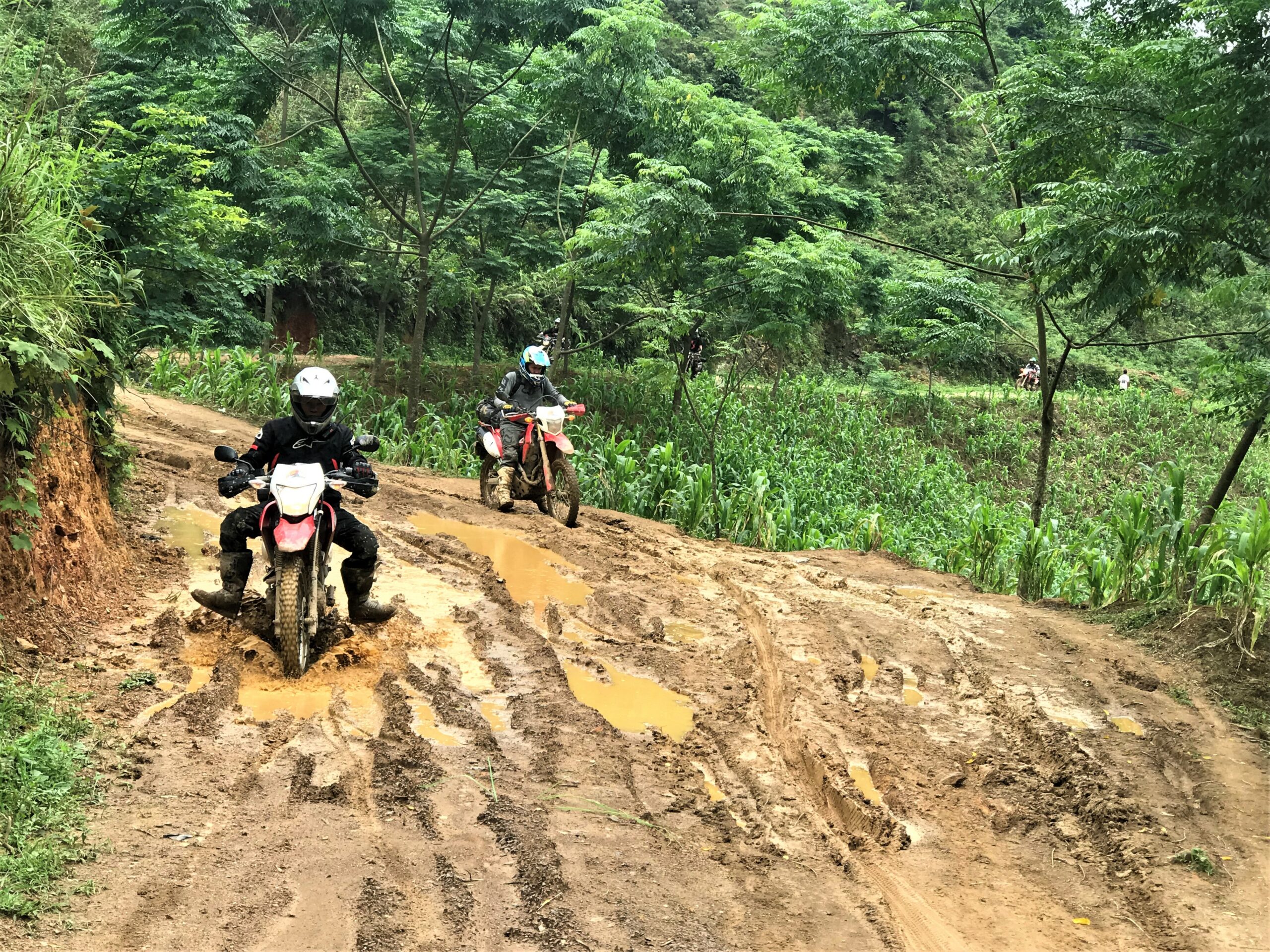 ride motorcycle in a muddy road in ha giang - best motorcycle rides in Vietnam