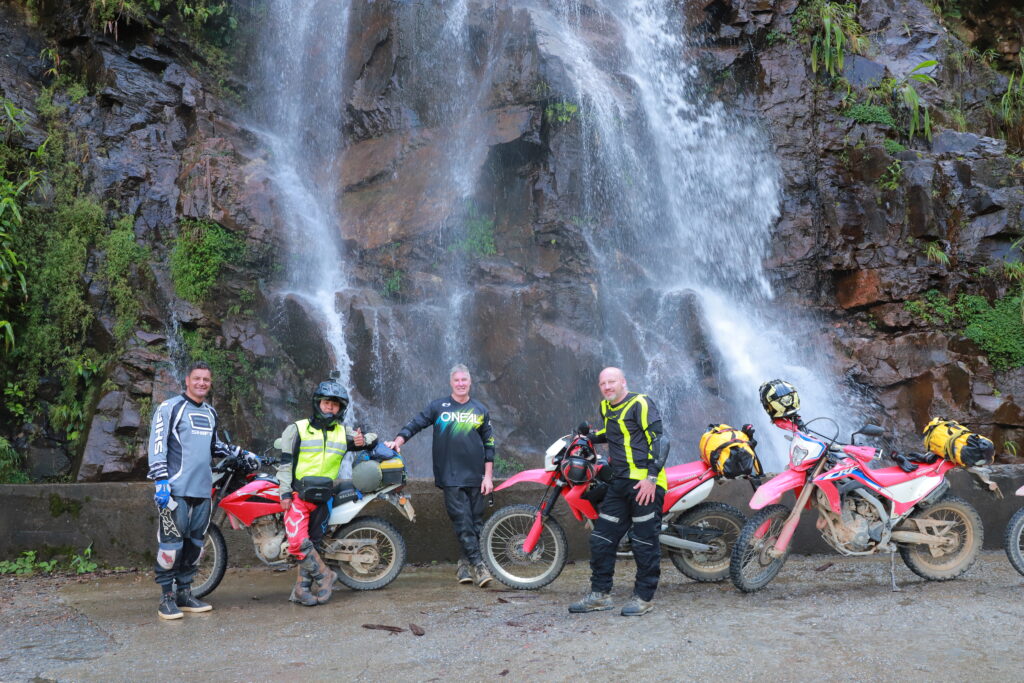 riders explore beautiful waterfall on moto adventures in Northern VIetnam